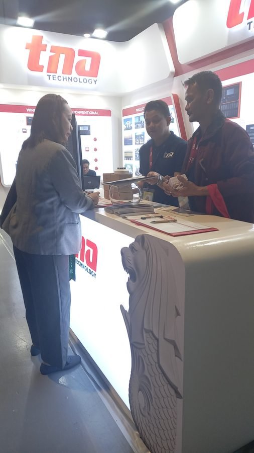 ITSP team member reviewing fire alarm system documentation at a vendor booth during WOSAS 2026